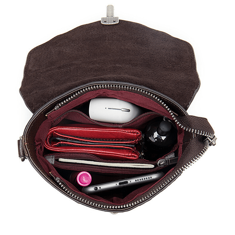 Inside view of a full grain leather shoulder purse with organized essentials including wallets and electronic devices.