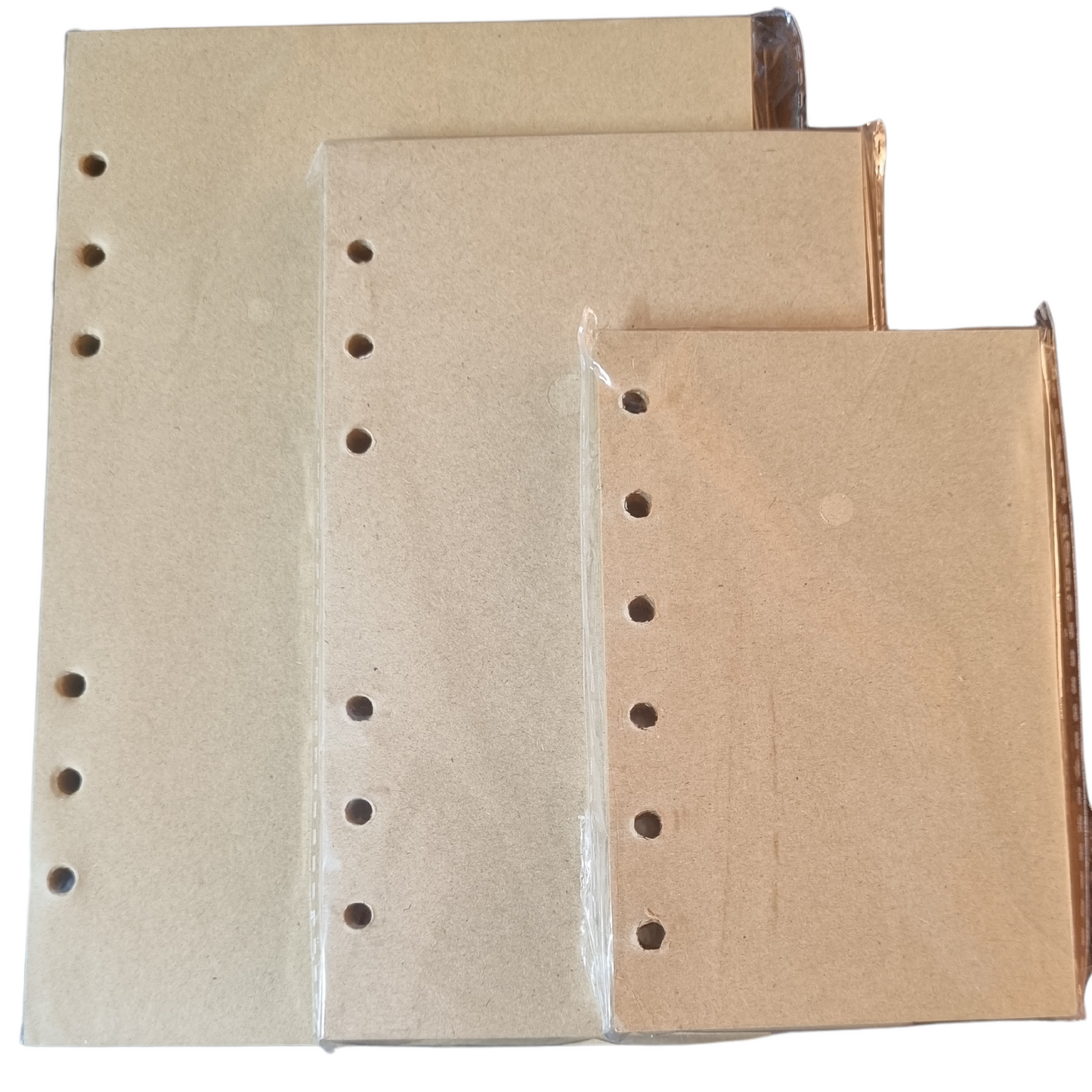 Set of three blank, unlined notebook covers with metal ring binder holes, perfect for custom travel journals.