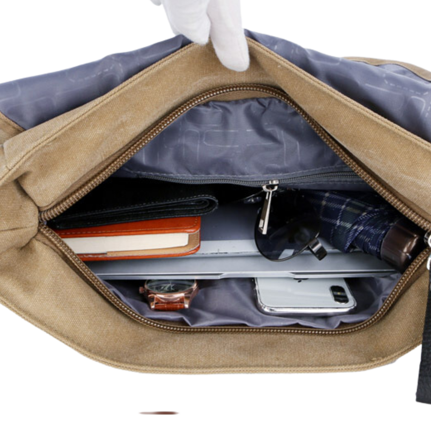Interior view of a large canvas satchel bag showing notebooks, glasses, and a phone organized inside.
