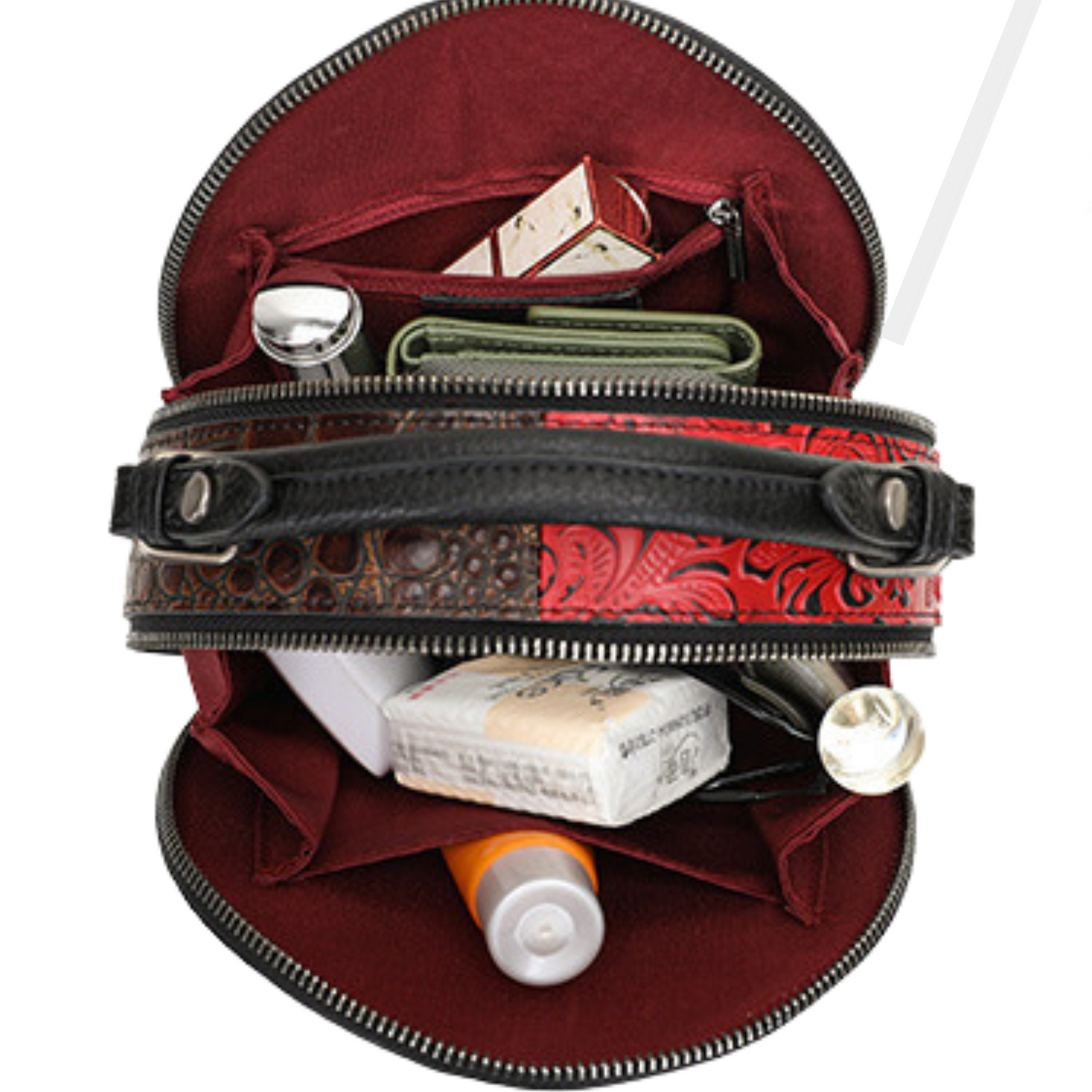 Interior view of a round cross body handbag showing organized compartments with cosmetics and essentials.