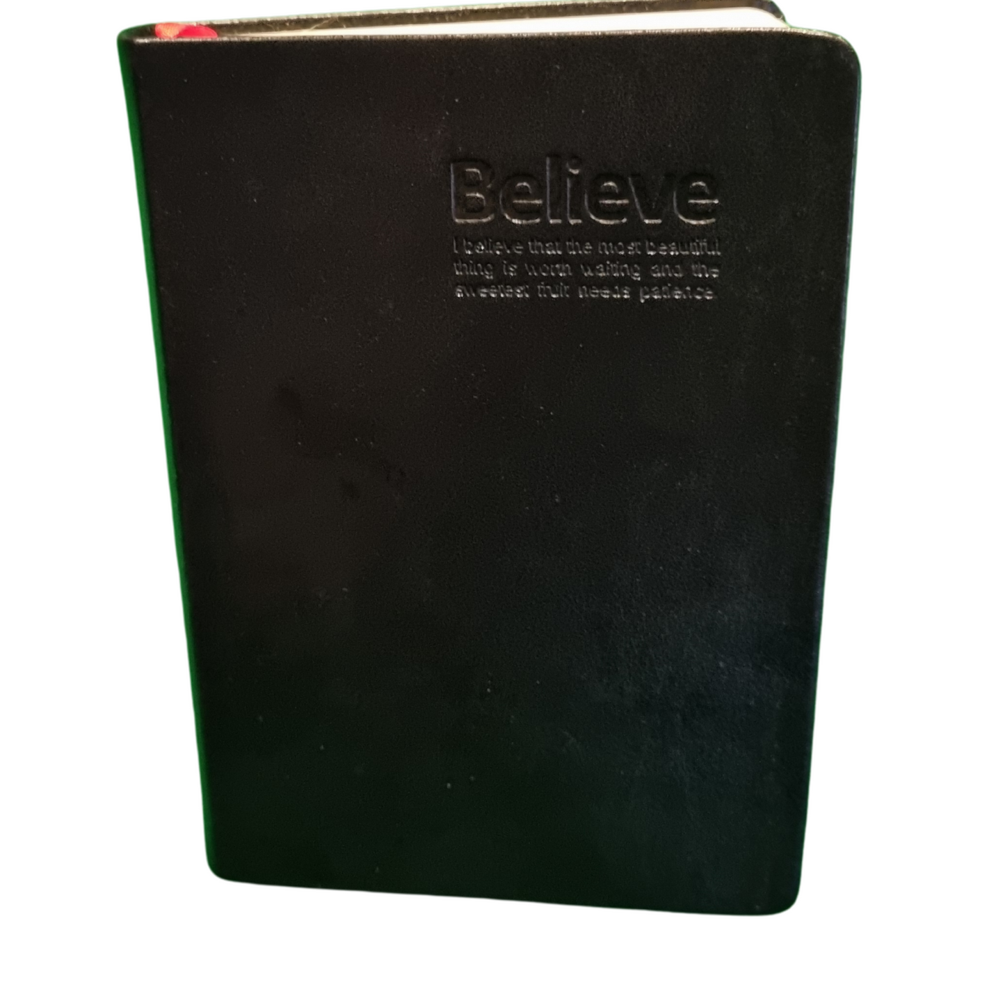 Black genuine leather travel journal with embossed 'Believe' quote and gold-edged pages.