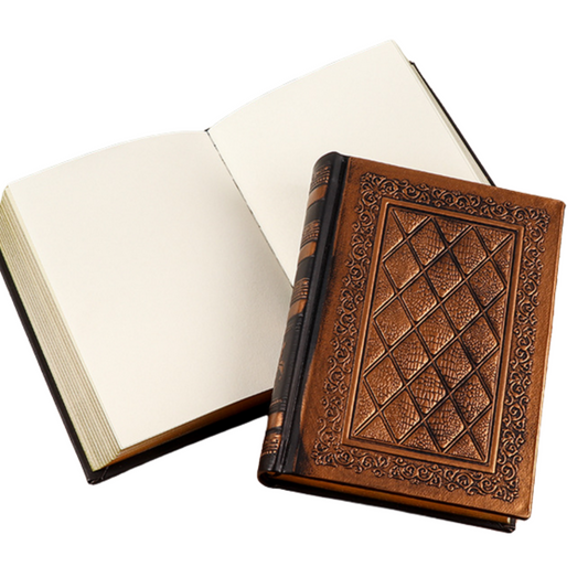 Handmade hard cover travel journal featuring gold edged blank leaflets and an intricately designed cover.