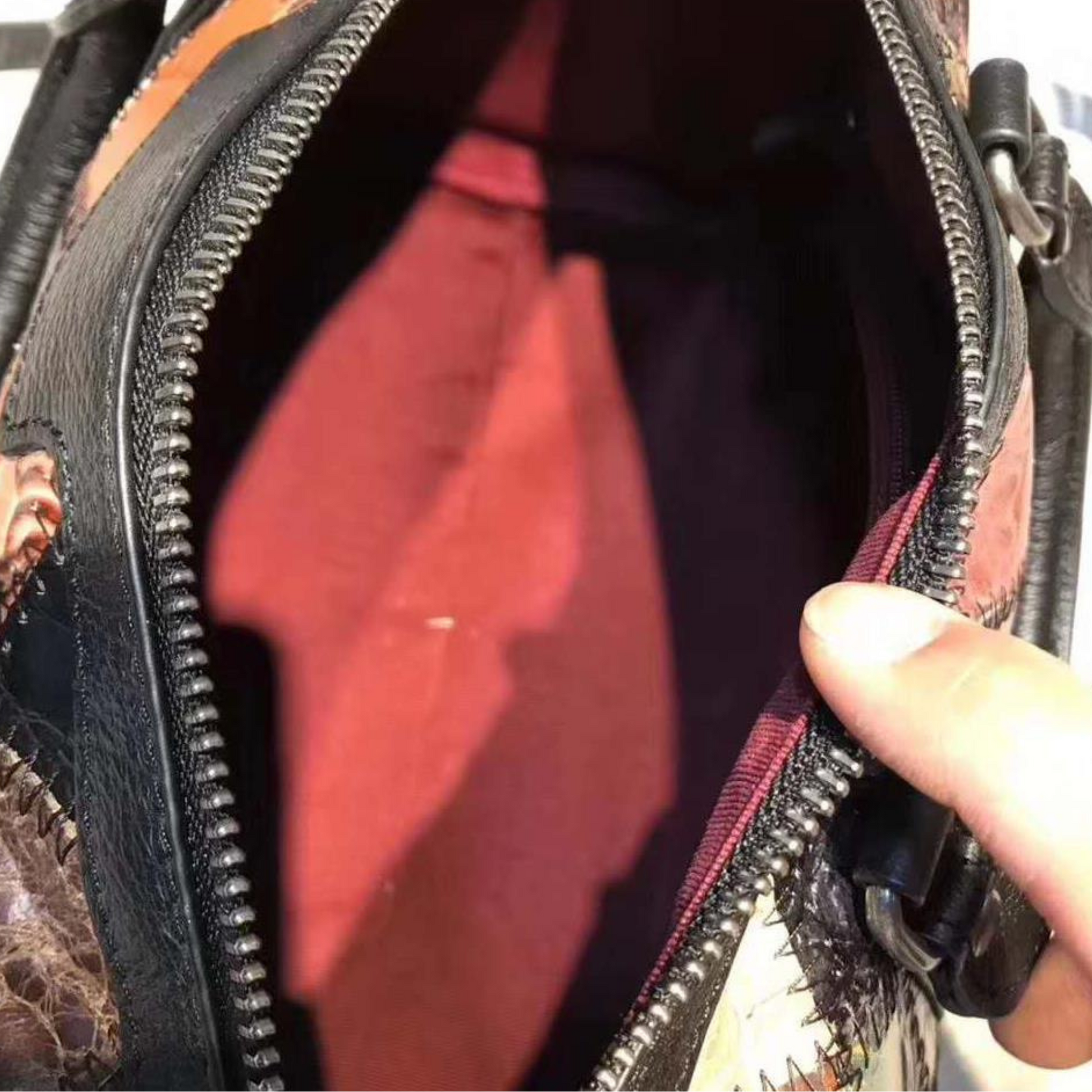 Interior view of Women's Genuine Leather Cross Body Shoulder Duffle Bag featuring spacious design and deep red lining.