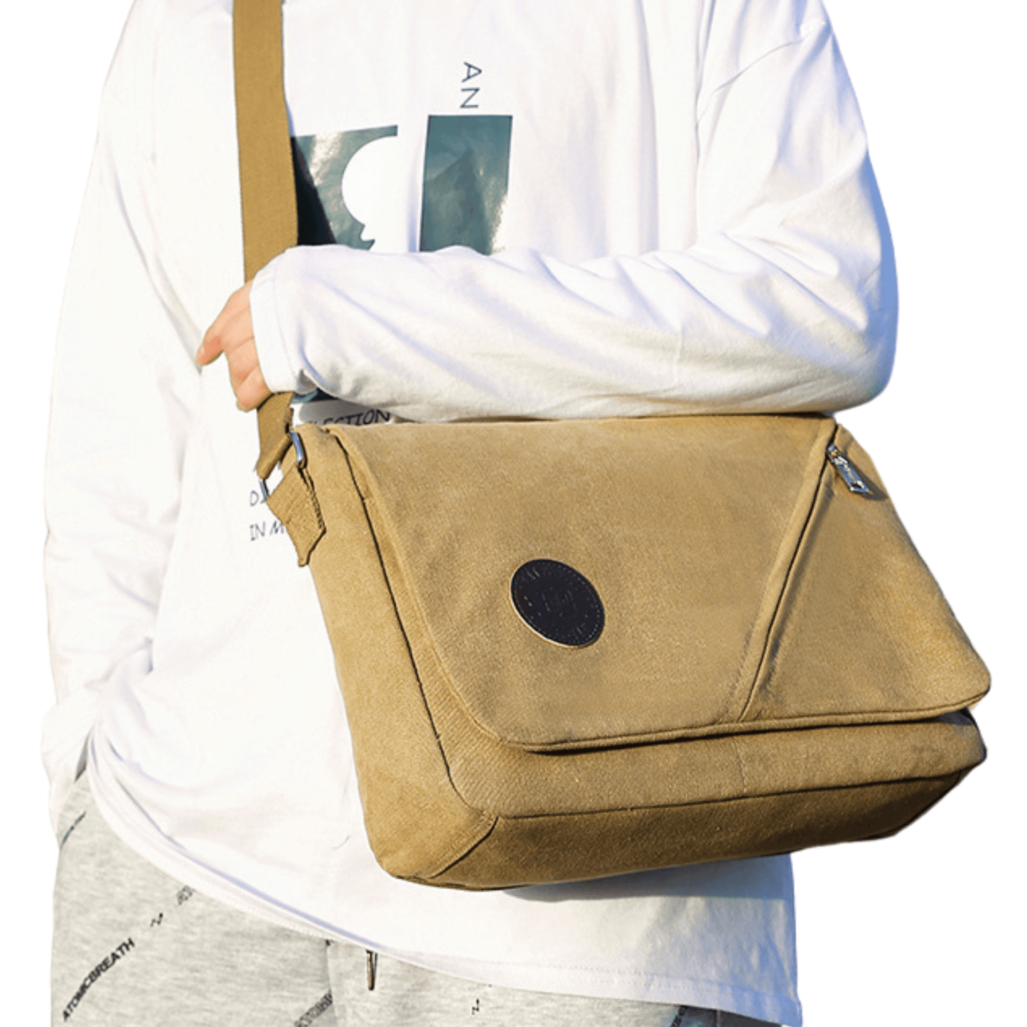 Canvas messenger bag with front flap zipper, worn casually by a person in a stylish outfit.