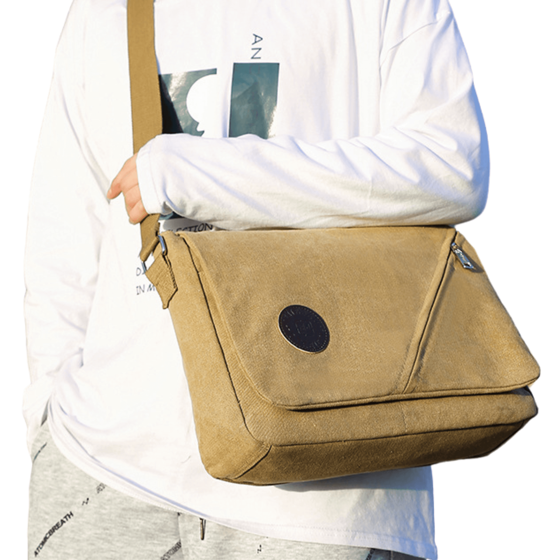 Canvas messenger bag with front flap zipper, worn casually by a person in a stylish outfit.