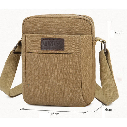 Small compact canvas messenger bag with adjustable strap and multiple pockets, ideal for travel and daily use.