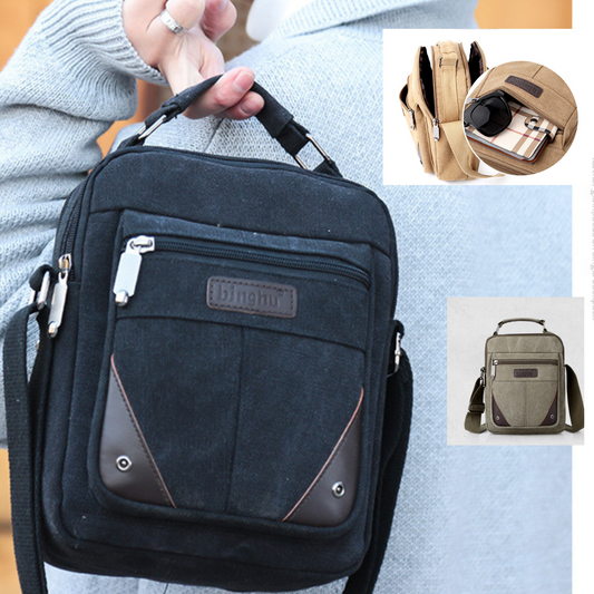 Compact designer canvas messenger bag for men and women, featuring multiple zip pockets in black.