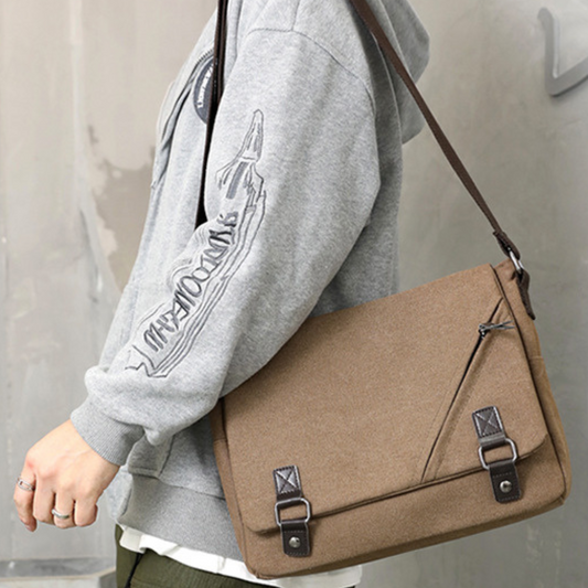 Stylish men's women's canvas cross body messenger satchel bag with adjustable strap and zipper closure.