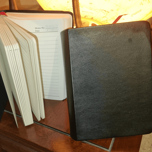 Black Genuine Leather Travel Journal showcasing 310 ruled pages, perfect for writing enthusiasts.