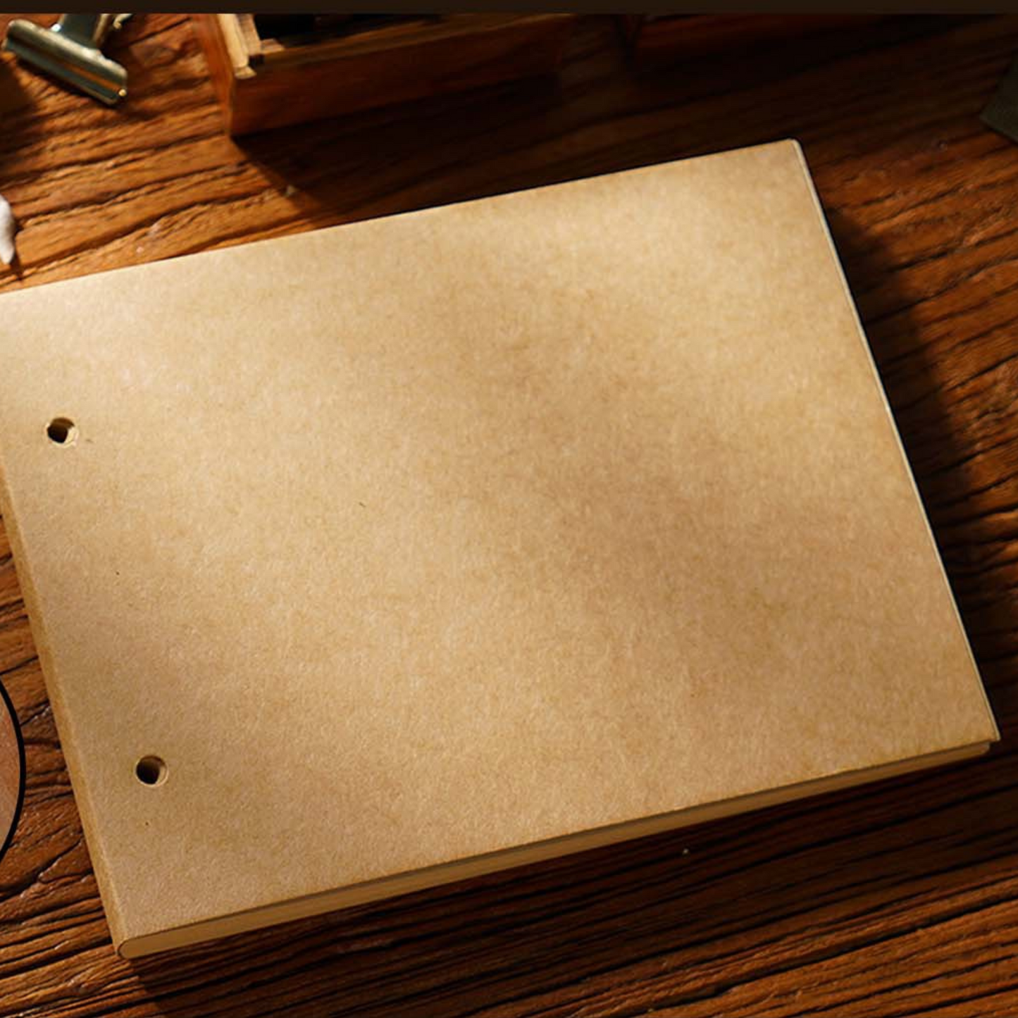 Blank sketchbook on a wooden table, ideal for travel journaling and creative sketches.