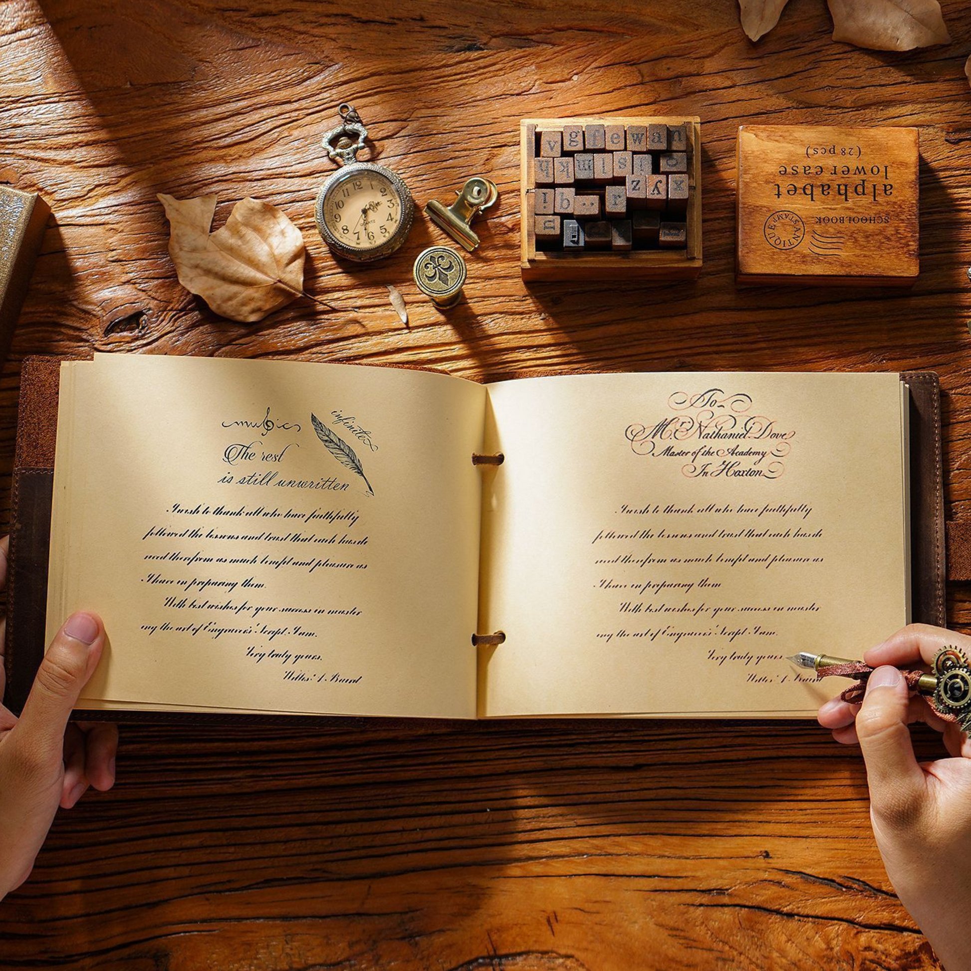 Open Crazy Horse leather-bound sketchbook travel journal on a rustic wooden table with vintage accessories.